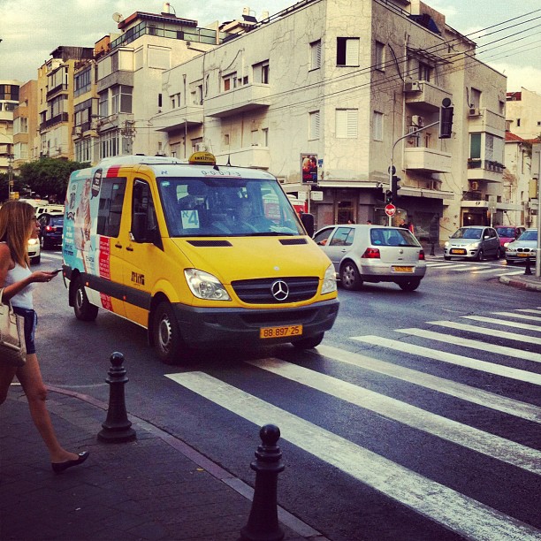 The Yellow Sheirut running along Ben Yehuda Street, Tel Aviv. One of Tel Aviv’s many public transportation options.Photo by Su Casa Tel Aviv Real Estate. All Rights Reserved. 